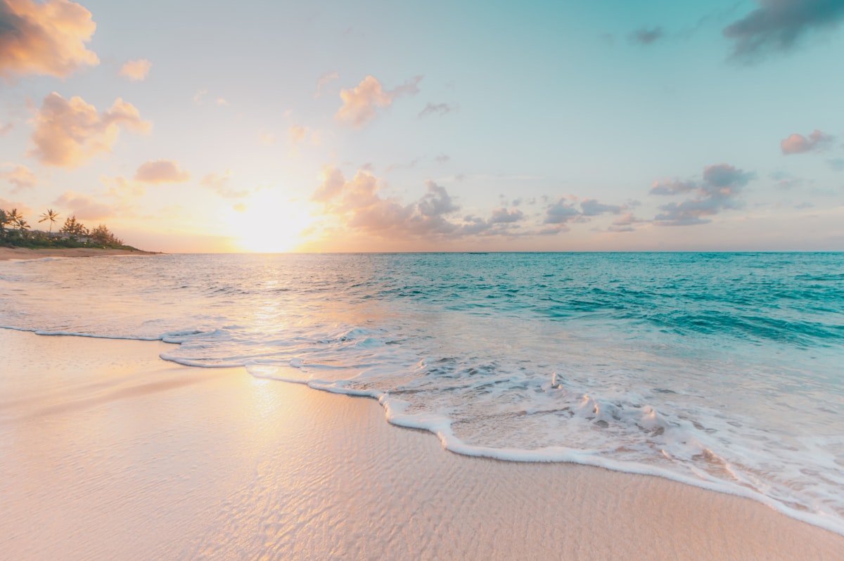 Golden-hour beach with shallow turquoise water